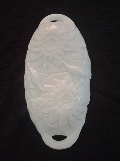 Milk glass oval dish with embossed sunflower or daisy pattern