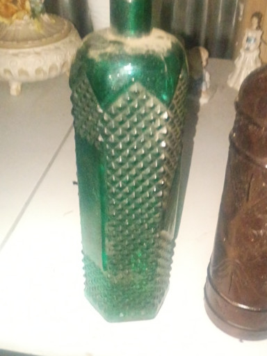 Green pressed glass decorative bottle with diamond hobnail pattern