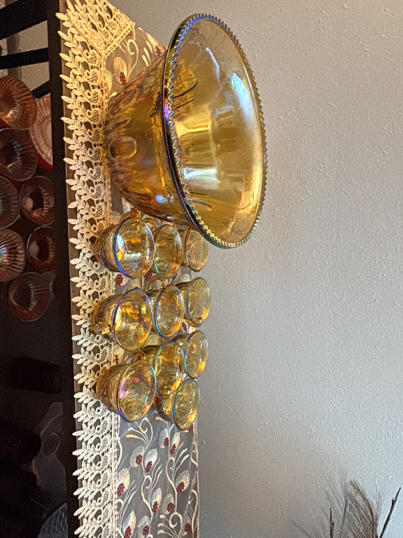 Amber carnival glass punch bowl set with 'Harvest Grape' pattern by Indiana Glass Company