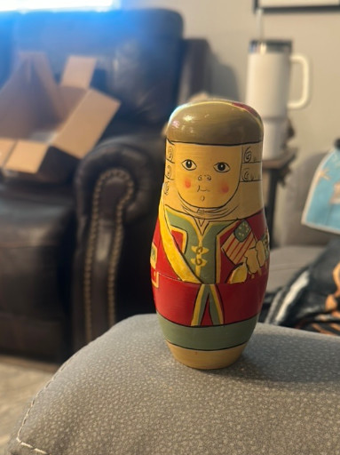 Vintage wooden Russian matryoshka (nesting doll) set depicting Soviet-era figures