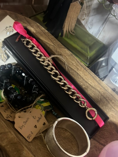 Gold-tone chain bracelet with pink leather accent