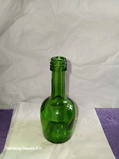 Green glass bottle, likely mid-20th century utilitarian or decorative vessel