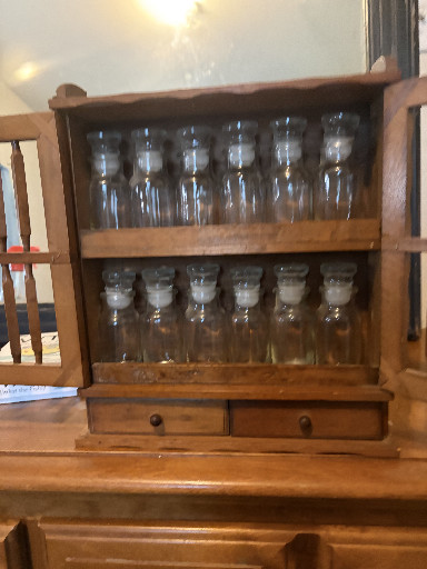 Vintage wooden spice rack with glass jars and drawer