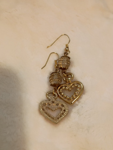 Gold-tone metal heart dangle earrings with decorative bead accents