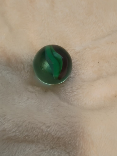 Glass marble with green swirl pattern