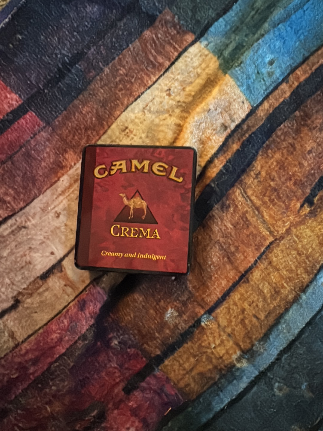 Metal advertising tin for Camel Crema cigarettes by R.J. Reynolds Tobacco Company