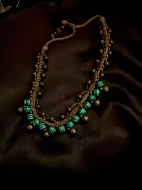 Handcrafted macramé necklace with green glass beads and brass accents