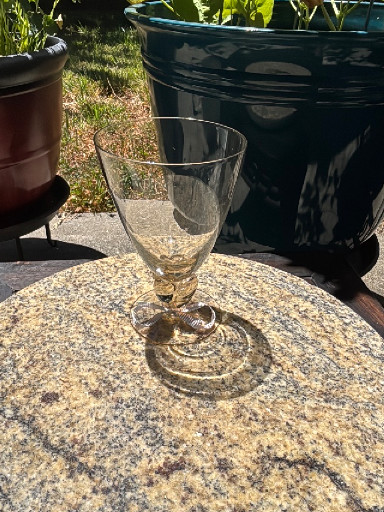 Clear glass wine or water goblet with pink base