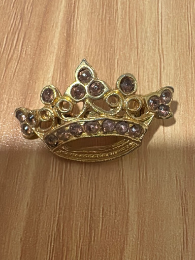 Gold-tone metal crown brooch with purple rhinestones and faux pearls