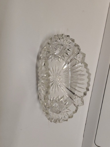 Cut glass crystal serving bowl with sawtooth edge and starburst pattern