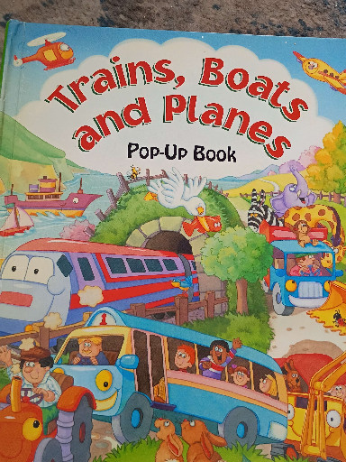 Children's pop-up book titled 'Trains, Boats and Planes' by Gill Davies, illustrated by Gill Guile