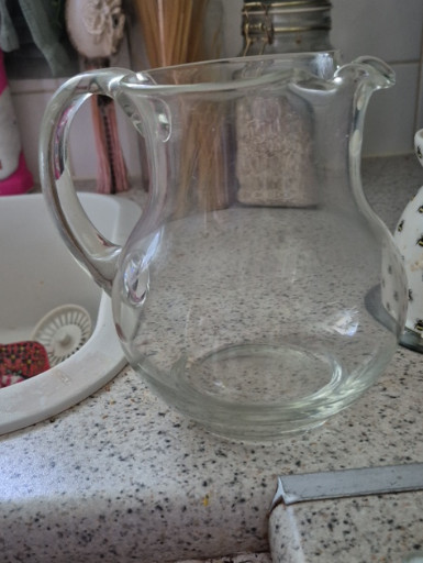Clear glass pitcher with applied handle and ice lip