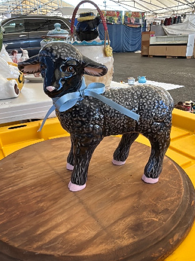 Folk art hand-painted ceramic black sheep figurine with blue ribbon