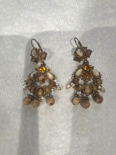 Vintage-style beaded chandelier earrings with brass-tone metal, amber-colored stones, and faux pearl drops
