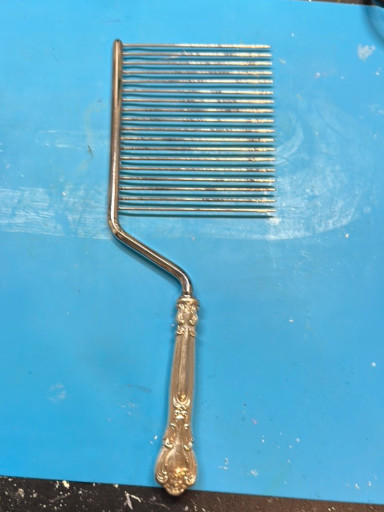 Sterling silver cake breaker with ornate floral handle