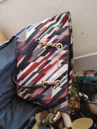 Synthetic leather tote bag with multicolor diagonal stripe pattern and gold-tone chain hardware