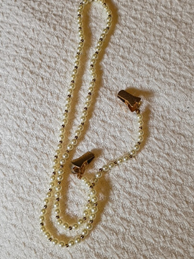 Vintage-style faux pearl sweater guard clip with gold-tone chain and alligator clips