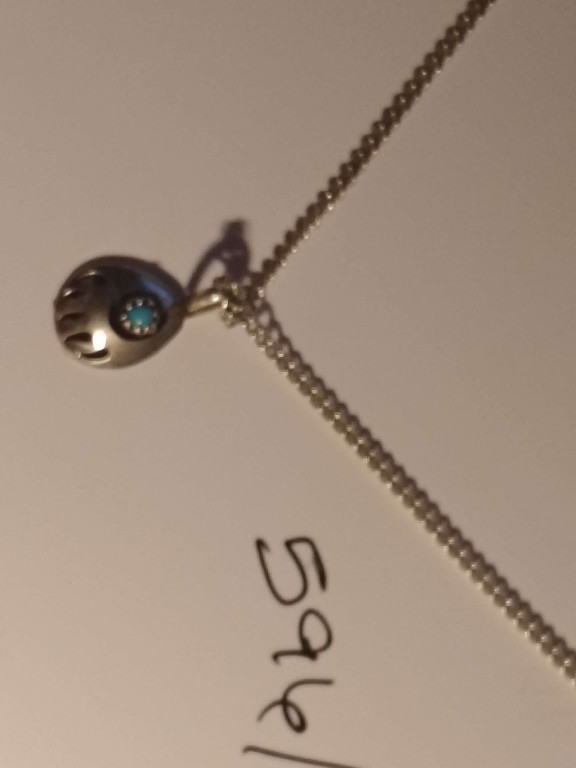 Sterling silver bear paw pendant with turquoise stone on silver chain