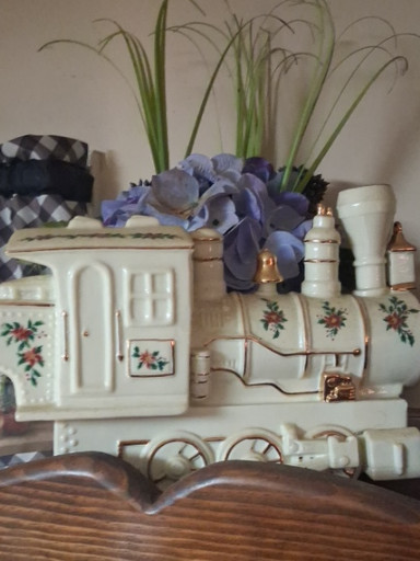 Ceramic holiday train locomotive with poinsettia and holly leaf decoration and gold trim