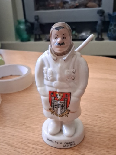 Porcelain crested china figurine titled 'Yours to a Cinder Old Bill' by Carlton China