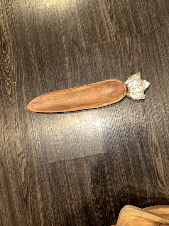Wood and pewter carrot-shaped serving tray with decorative metal leaf accent