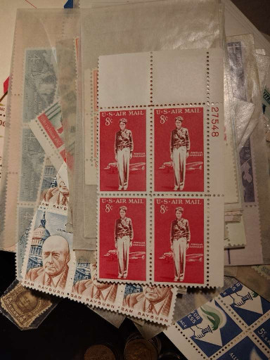 Collection of vintage U.S. airmail stamps featuring Amelia Earhart (Scott #C68, 8¢, 1963) and other assorted U.S. postage stamps from mid-20th century