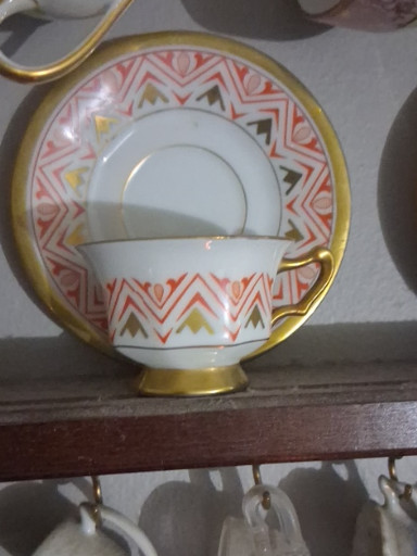 Porcelain tea cup and saucer set with Art Deco chevron pattern and gilt accents, likely German manufacture
