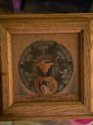 Native American sand art painting depicting a pottery vessel with traditional design in wooden frame
