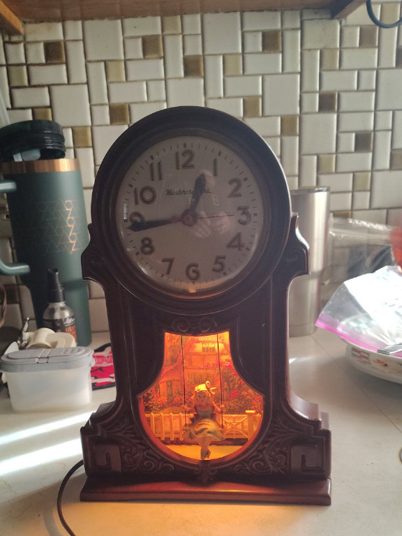 Bakelite electric motion clock titled 'Swingtime' by Mastercrafters