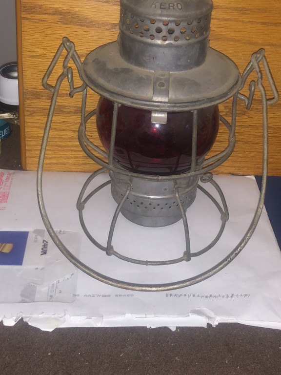 Vintage railroad lantern with red globe marked 'KERO'