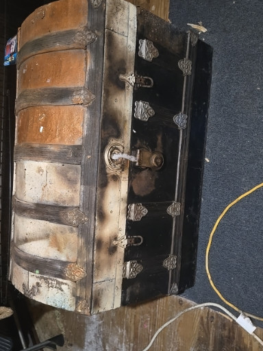 Dome-top steamer trunk with metal hardware and wooden slat construction