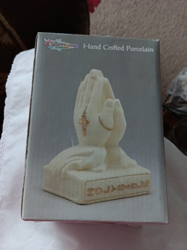 Hand-crafted porcelain figurine titled 'Praying Hands on Holy Bible' by Treasures of Faith