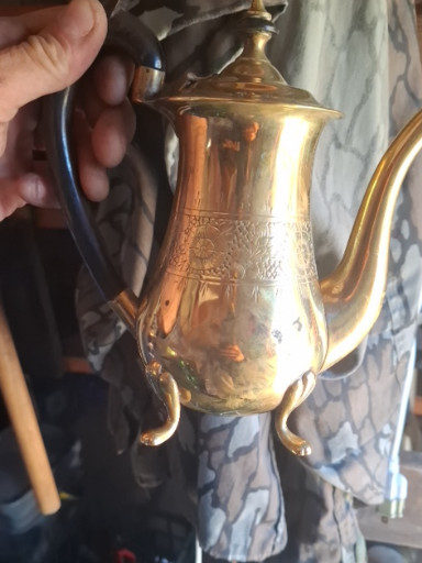 Brass coffee pot with engraved floral decoration and ornate lid