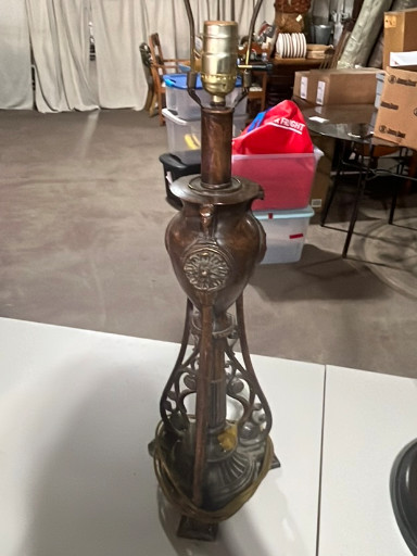Bronze-style metal table lamp base with ornate openwork design and decorative medallions