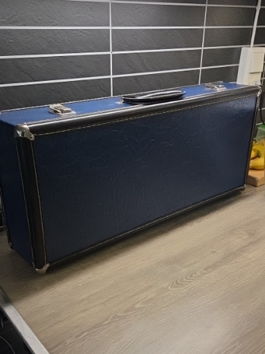 Vintage hard-shell carrying case in navy blue vinyl with black edging and metal hardware