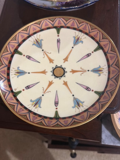 Hand-painted porcelain decorative plate with Egyptian Revival motifs featuring lotus flowers and papyrus reeds
