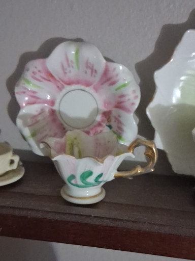 Porcelain teacup and saucer set with hand-painted pink floral decoration