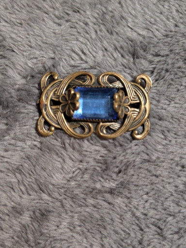 Brass brooch with blue glass stone in Art Nouveau style