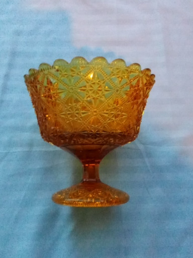 Amber glass pedestal compote with diamond point pattern
