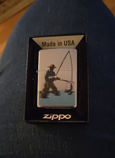 Zippo lighter with fly fisherman design
