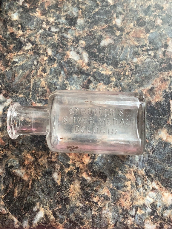 Glass cologne bottle labeled 'Strother's Silver Medal Cologne'