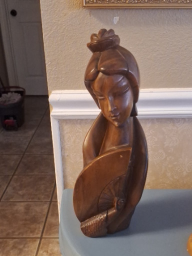 Hand-carved wood sculpture depicting a woman holding a child