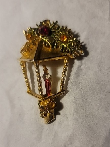 Vintage gold-tone metal Christmas lantern brooch with enamel and rhinestone accents