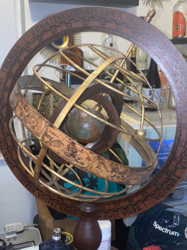 Wooden armillary sphere with zodiac engravings on wooden stand
