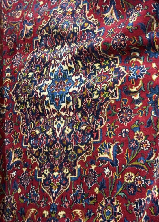 Hand-knotted wool Persian Kashan rug with traditional medallion design on burgundy field
