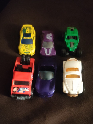 Collection of six vintage die-cast toy cars including Hot Wheels and Matchbox vehicles from the 1970s-1980s