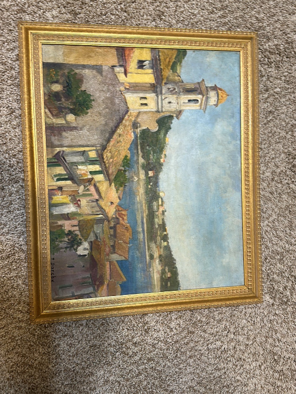 Oil painting depicting a European village scene with church and buildings along a waterway by an unidentified artist