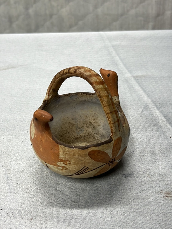 Terracotta pottery vessel with arched handle, likely Southwestern Native American or North African origin