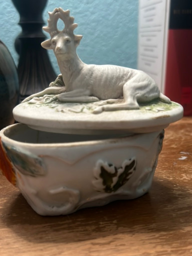 Ceramic trinket box with recumbent deer or stag finial