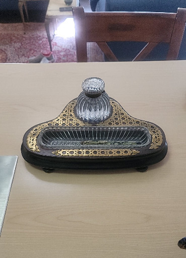 Victorian-era ebonized wood inkstand with brass Boulle-style inlay and cut glass inkwell